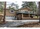 A charming multi-story home with a brick facade, decks, and a two-car garage at 5382 S Pine Rd, Evergreen, CO 80439