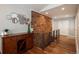 Stylish hallway with rustic brick accent wall, showcasing wood flooring and contemporary decor at 5382 S Pine Rd, Evergreen, CO 80439