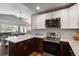 Open kitchen showcasing granite countertops, stainless appliances, and seamless flow to the living area at 5382 S Pine Rd, Evergreen, CO 80439