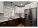 Bright kitchen with stainless steel refrigerator, white countertops, modern fixtures and abundant storage at 5382 S Pine Rd, Evergreen, CO 80439