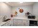 Well-lit kitchenette featuring ample counter space, stylish white cabinets, and modern appliances at 5382 S Pine Rd, Evergreen, CO 80439