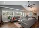 Bright living room with large windows, hardwood floors, and a comfortable gray sectional sofa at 5382 S Pine Rd, Evergreen, CO 80439