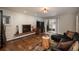 Charming living room featuring a fireplace, hardwood floors, and sliding doors leading to the outdoors at 5382 S Pine Rd, Evergreen, CO 80439