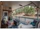 Inviting covered porch with comfortable seating, a fire pit, and string lights for ambiance at 5382 S Pine Rd, Evergreen, CO 80439