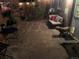 Evening view of backyard with stone patio, outdoor seating, and lush greenery at 5018 E 8Th Ave, Denver, CO 80220