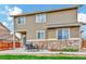 Exterior of home with stone and siding on an expansive lot with a patio at 471 N Jackson Gap Way, Aurora, CO 80018