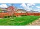 An expansive backyard with lush green grass and a well-maintained wooden fence at 471 N Jackson Gap Way, Aurora, CO 80018