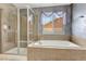 Bright bathroom boasts a soaking tub and separate glass-enclosed shower at 471 N Jackson Gap Way, Aurora, CO 80018