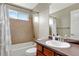 This bathroom features tile surround, shower and tub, and a single vanity at 471 N Jackson Gap Way, Aurora, CO 80018