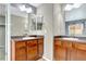 Bathroom featuring dual sinks and a large vanity mirror at 471 N Jackson Gap Way, Aurora, CO 80018