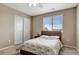 This bedroom has a neutral color scheme, carpeted floors, and a double closet for ample storage at 471 N Jackson Gap Way, Aurora, CO 80018