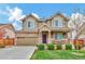 Charming two-story home with stone accents, manicured lawn and a two car garage in a residential neighborhood at 471 N Jackson Gap Way, Aurora, CO 80018