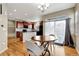 Open concept kitchen with wood floors, island seating, and sliding glass door leading to the backyard at 471 N Jackson Gap Way, Aurora, CO 80018