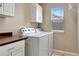 Bright laundry room featuring modern washer and dryer, and extra storage space at 471 N Jackson Gap Way, Aurora, CO 80018