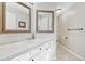 Bright bathroom featuring double mirrors, a white vanity and a tiled floor at 598 Crossing Cir, Castle Pines, CO 80108