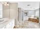 Large bathroom featuring a jacuzzi tub, a tiled floor, a walk-in shower and double vanities at 598 Crossing Cir, Castle Pines, CO 80108