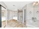 Large bathroom featuring a walk-in shower, a jacuzzi tub, a tiled floor and double vanities at 598 Crossing Cir, Castle Pines, CO 80108