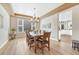 Charming dining room featuring a chandelier, and hardwood floors with a view of an open kitchen at 598 Crossing Cir, Castle Pines, CO 80108