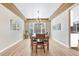 Elegant dining room featuring a stylish chandelier, large windows, and hardwood floors at 598 Crossing Cir, Castle Pines, CO 80108