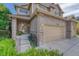 Beautiful brick home with a three-car garage, a covered front porch, and well-maintained landscaping at 598 Crossing Cir, Castle Pines, CO 80108