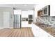 Bright kitchen featuring stainless steel appliances, granite countertops and white cabinets at 598 Crossing Cir, Castle Pines, CO 80108