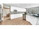 Modern kitchen featuring white cabinets, granite countertops, stainless steel appliances, and hardwood floors at 598 Crossing Cir, Castle Pines, CO 80108