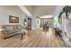 Open concept living room with a grand staircase, hardwood floors, and a view to the formal dining area at 598 Crossing Cir, Castle Pines, CO 80108