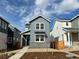 Charming two-story home featuring gray siding, white trim, and a welcoming front yard at 3325 N Coolidge Way, Aurora, CO 80019