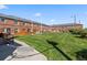 Backyard featuring communal laundry and storage. Well-maintained grass surrounded by brick buildings at 2872 Jasmine St, Denver, CO 80207