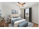 Stylish bedroom with a modern decor features a bright window with side tables on each side of the bed at 2872 Jasmine St, Denver, CO 80207