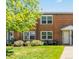 Brick townhome featuring a well-maintained lawn, mature trees and updated windows at 2872 Jasmine St, Denver, CO 80207