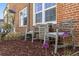 Comfortable outdoor seating area with wooden chairs and brick exterior providing a serene space at 2872 Jasmine St, Denver, CO 80207