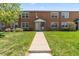Charming two-story brick townhouse with a well-maintained front yard and inviting entrance at 2872 Jasmine St, Denver, CO 80207