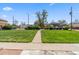 Green front yard with a concrete path, landscaping and clear blue skies above at 2872 Jasmine St, Denver, CO 80207