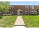 Charming brick apartment featuring a well-maintained lawn and inviting entryway at 2872 Jasmine St, Denver, CO 80207
