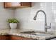 Close-up of a kitchen sink and countertop with white subway tile backsplash and granite counters at 2872 Jasmine St, Denver, CO 80207