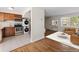 Inviting living room seamlessly connected to a kitchen with stacked laundry appliances at 2872 Jasmine St, Denver, CO 80207