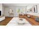 Comfortable living area with hardwood floors, a cozy couch, and a view of the outdoors at 2872 Jasmine St, Denver, CO 80207