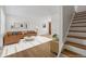 A welcoming living space featuring hardwood floors and a staircase to the upper level at 2872 Jasmine St, Denver, CO 80207