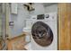 Bathroom features a toilet and a modern washing machine with a dark glass door at 1080 Ski Hill Rd # 9, Breckenridge, CO 80424