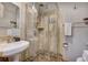 Bathroom features a glass shower, sink with pedestal, and tiled walls at 1080 Ski Hill Rd # 9, Breckenridge, CO 80424