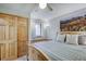 Bedroom with a full sized bed, wood trim, wood doors, and a mountain picture at 1080 Ski Hill Rd # 9, Breckenridge, CO 80424