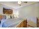 Bedroom with light gray walls, wood trim, a ceiling fan, and a wooden bedframe at 1080 Ski Hill Rd # 9, Breckenridge, CO 80424