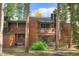 Inviting two-story condo with wood siding and private balconies nestled among the trees at 1080 Ski Hill Rd # 9, Breckenridge, CO 80424