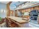 Kitchen and dining area with wood beams, bar seating, and stainless steel appliances at 1080 Ski Hill Rd # 9, Breckenridge, CO 80424