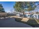 Large fenced backyard featuring a curved concrete patio with a seating area and mature trees at 3151 E 134Th Cir, Thornton, CO 80241