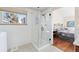 Modern bathroom with glass-enclosed shower, window, and adjacent bedroom at 3151 E 134Th Cir, Thornton, CO 80241