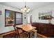 Inviting dining area with classic wood furniture, ample natural light, and stylish lighting at 3151 E 134Th Cir, Thornton, CO 80241