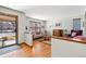 Comfortable living room with hardwood floors, a patterned sofa, and natural light from the entry at 3151 E 134Th Cir, Thornton, CO 80241