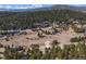 Breathtaking aerial view of a home situated in a tranquil, forested area, showcasing the natural beauty at 30455 Telluride Ln, Evergreen, CO 80439